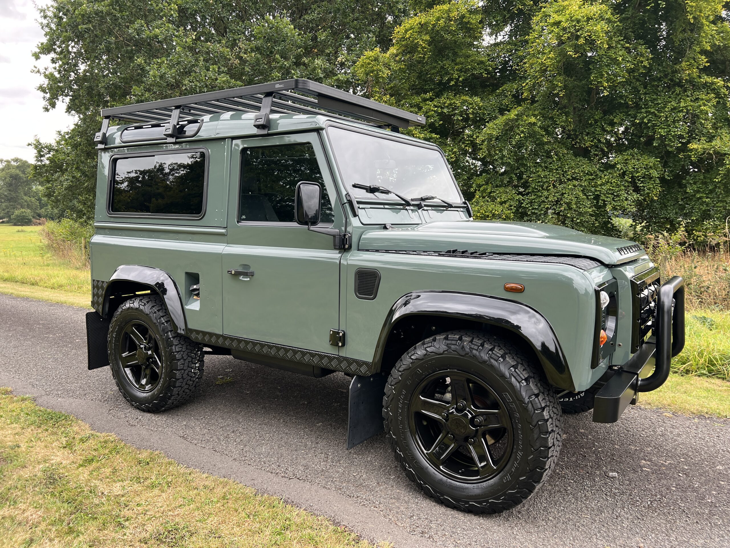 green restored land rover defender